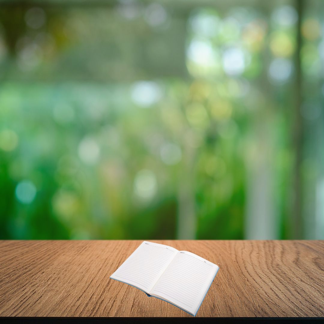 Open A5 notebook showing lined 80 GSM writing pages