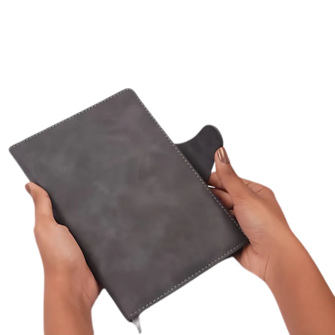 Grey A5 PU notebook with magnetic flap lock, held in hands