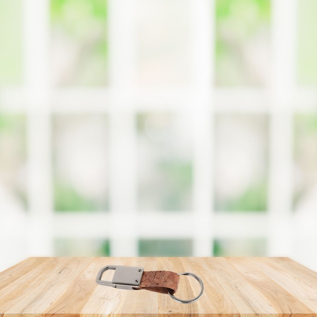 Rectangle metal keychain with cork strap on table