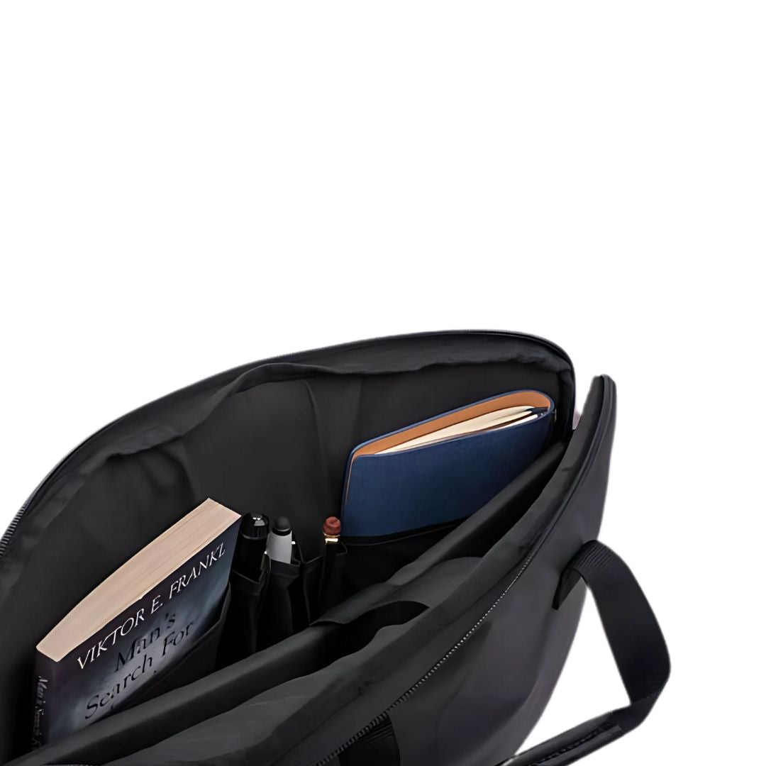 Black laptop bag with books, pens, and notebook inside