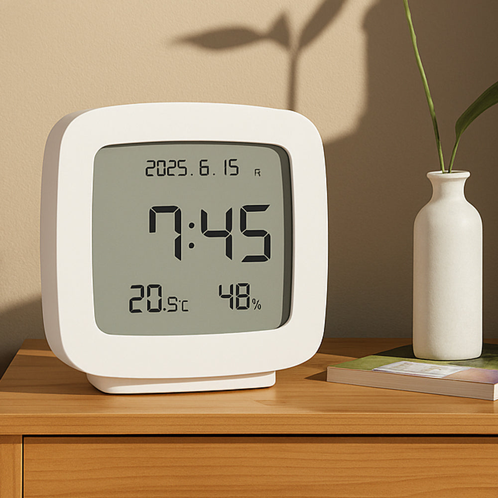 TV-style digital clock with calendar, temperature and humidity display on bedside table