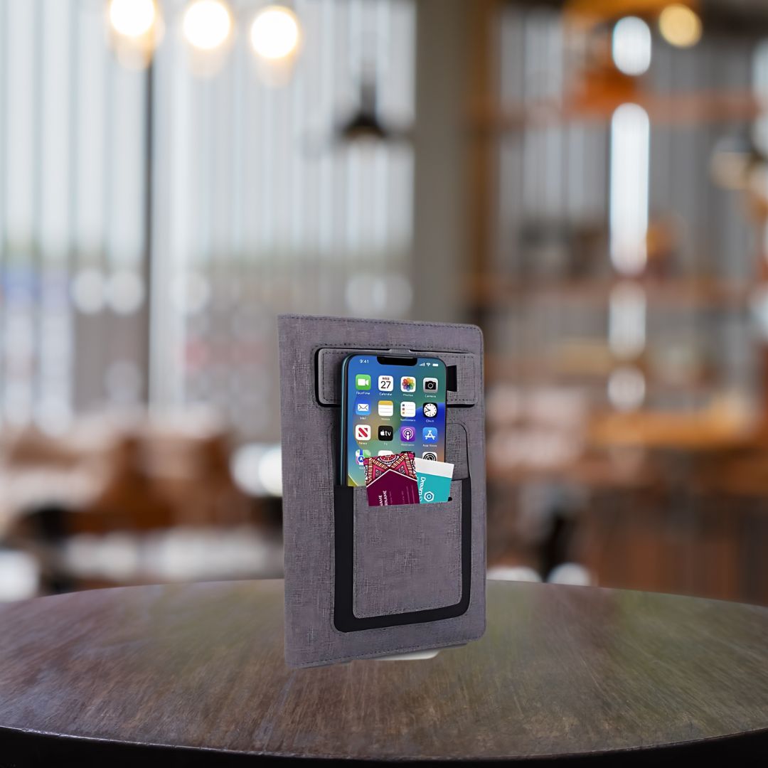 Lifestyle shot of multifunctional A5 notebook with phone and cards