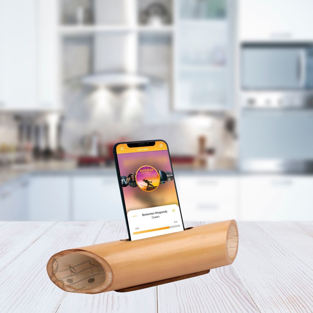 Bamboo music amplifier with smartphone in modern kitchen setting