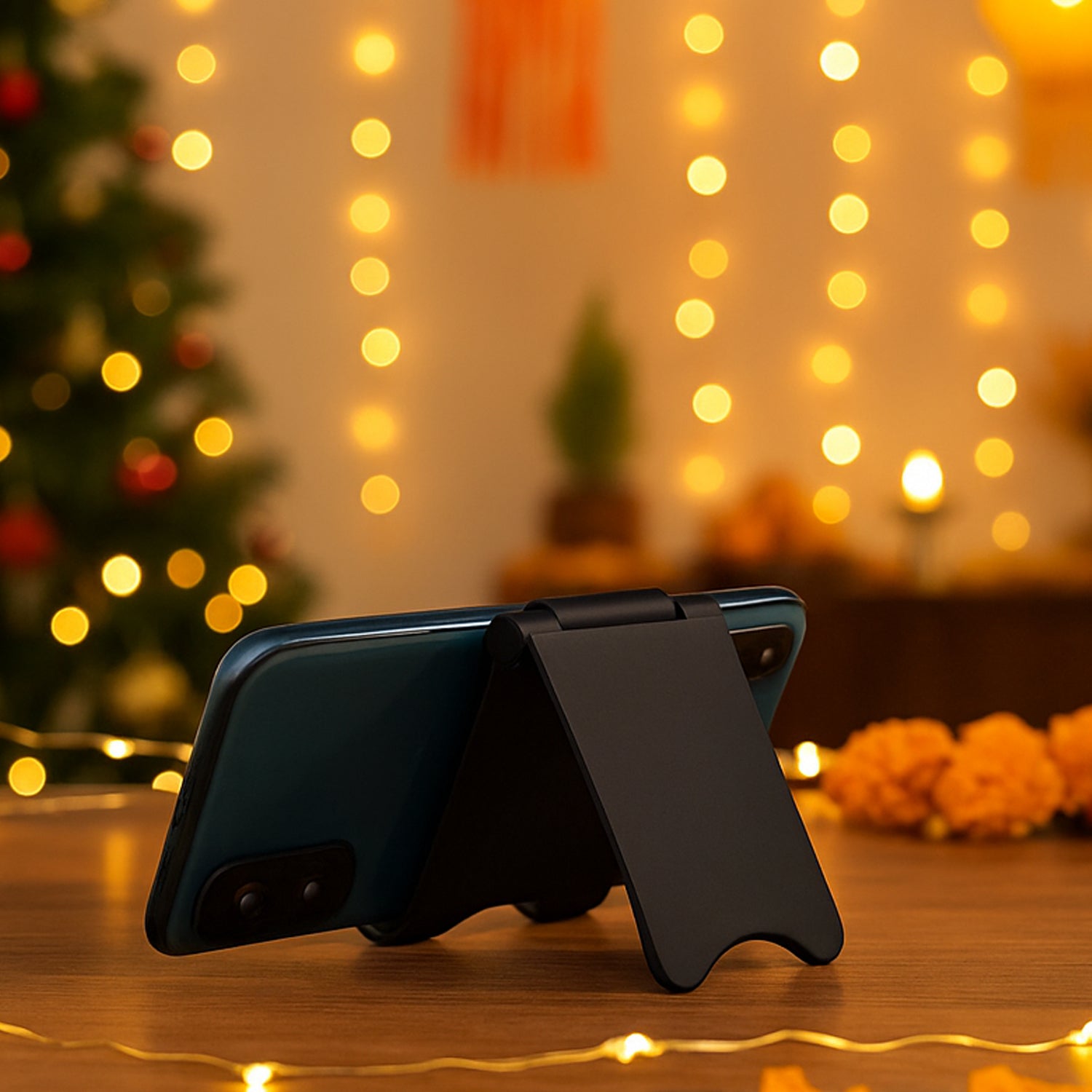 Adjustable mobile stand holding smartphone on wooden desk