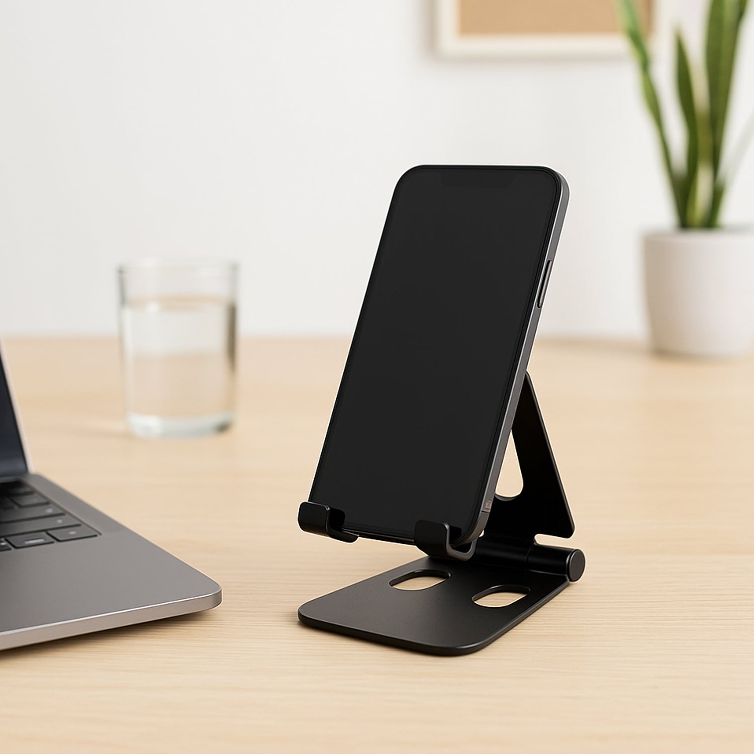 Flexo Mini 2 folding metal mobile stand in compact folded position on wooden table