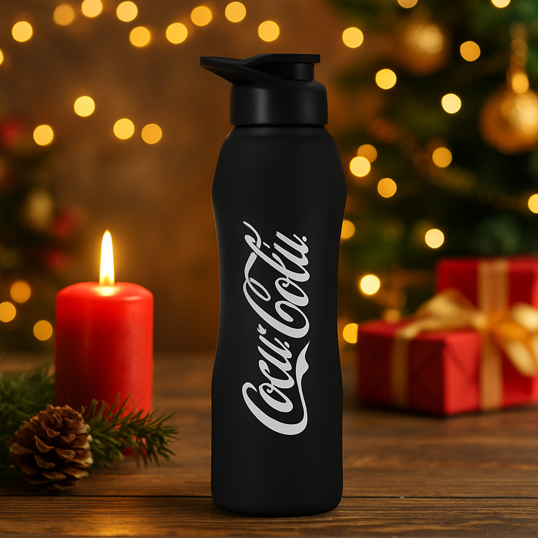Black stainless steel water bottle placed on wooden table in modern kitchen