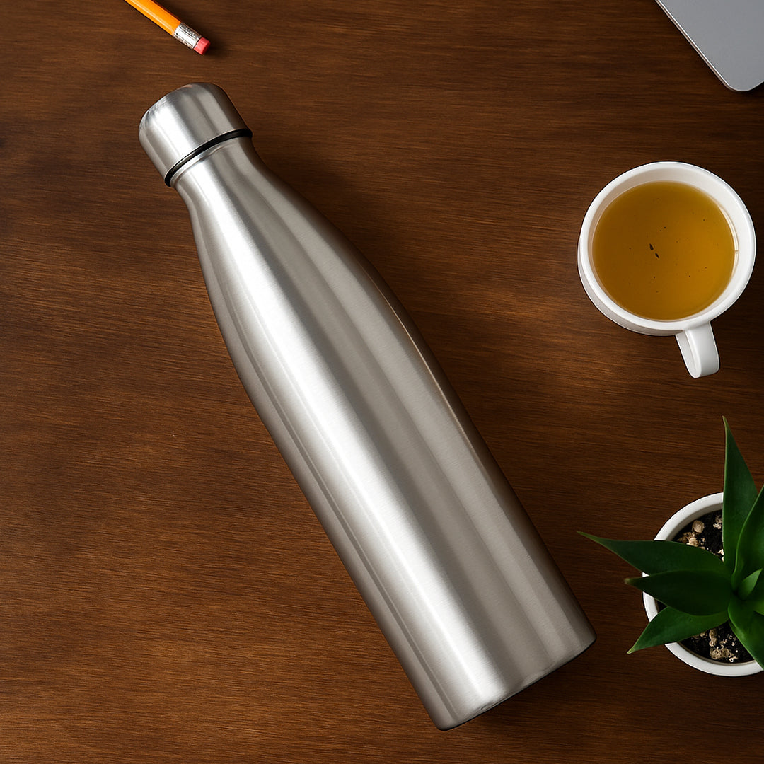 Stainless steel single wall cola bottle 750ml on desk with tea cup