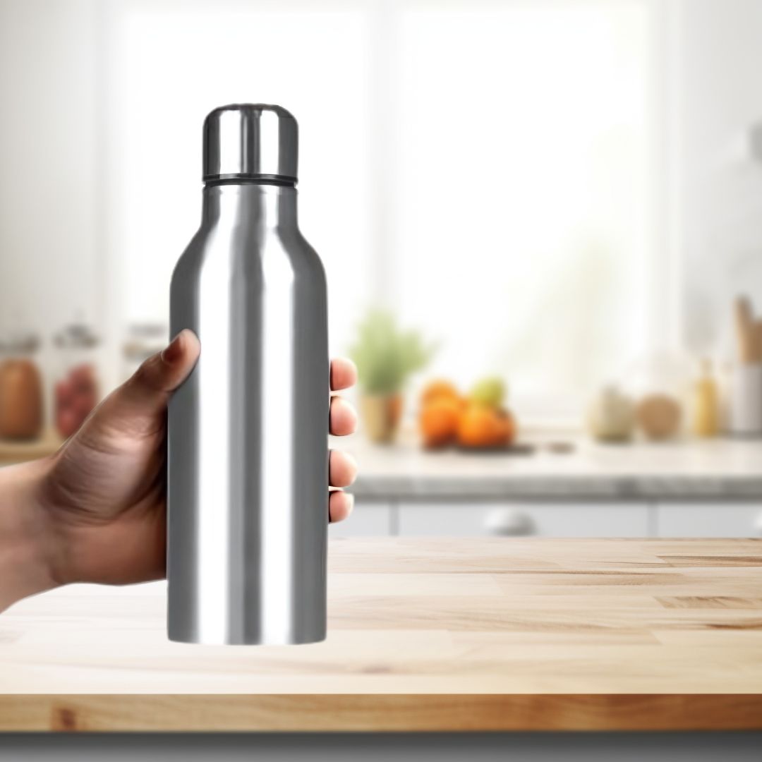 Stainless steel water bottle with carry strap held in hand – lifestyle kitchen background