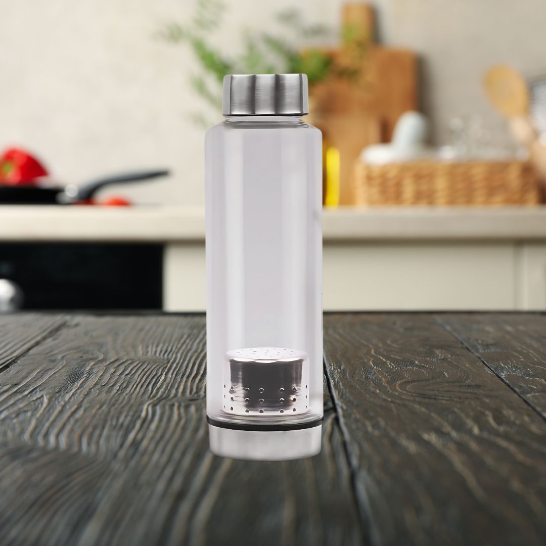 Lifestyle shot of borosilicate glass bottle with steel infuser on kitchen counter