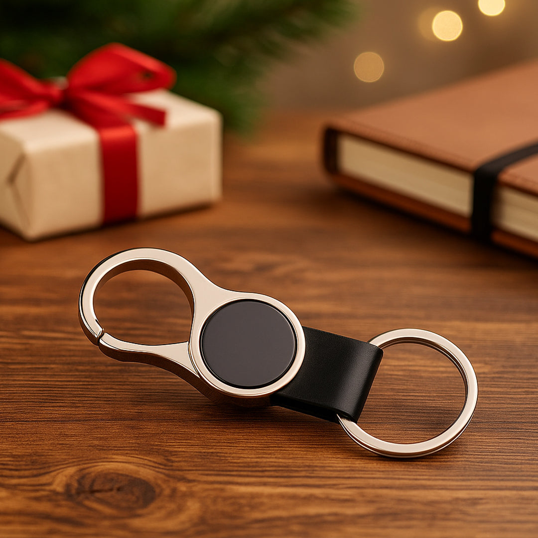 Round hanging metal keychain with PU strap, gunmetal finish, flat lay view