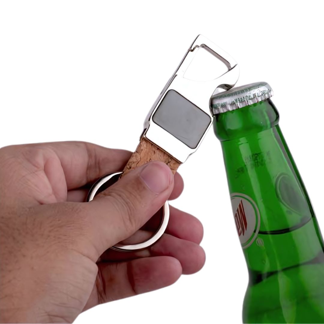 Rectangle hanging metal keychain with cork strap being used as a bottle opener