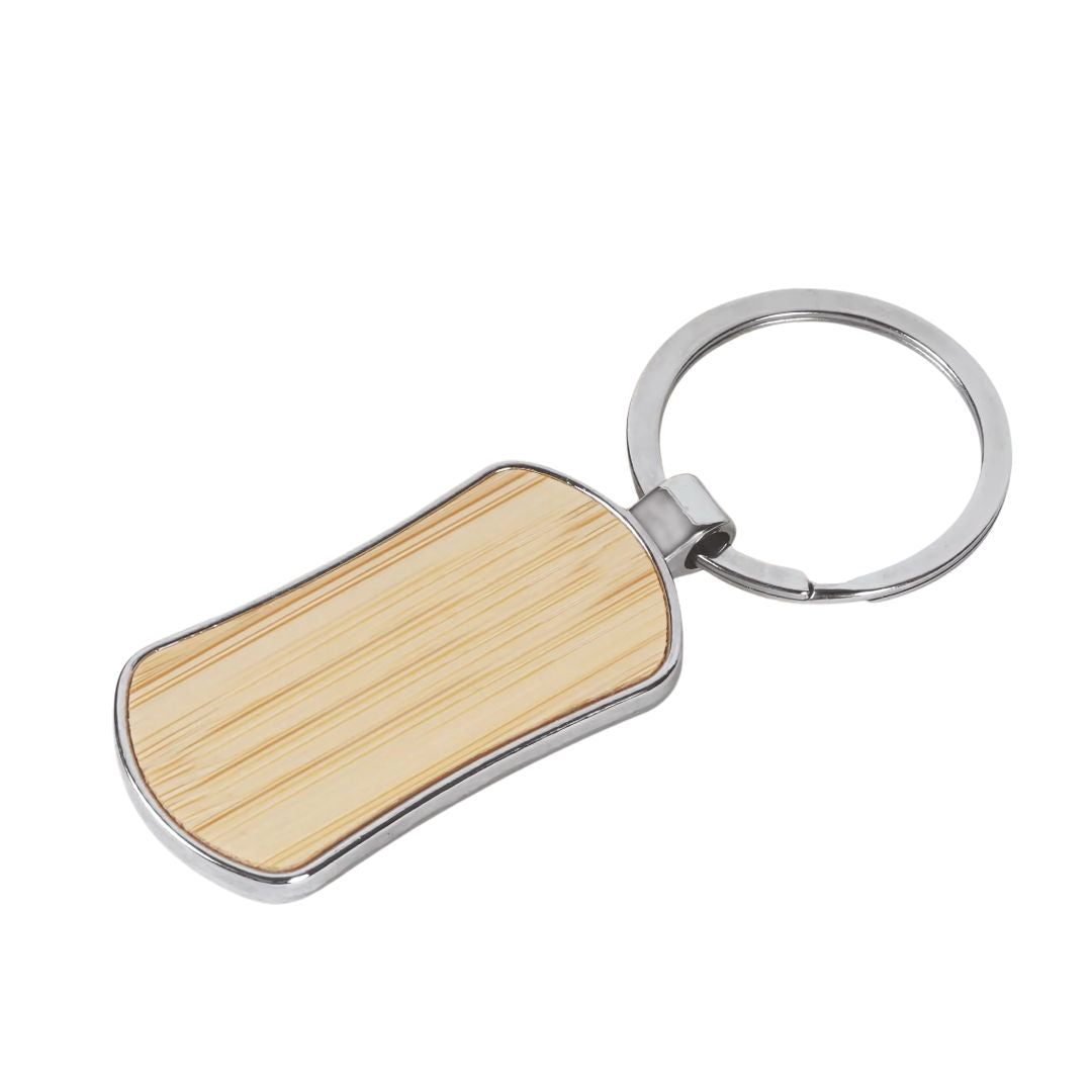 Eco-friendly bamboo and metal keychain on wooden table