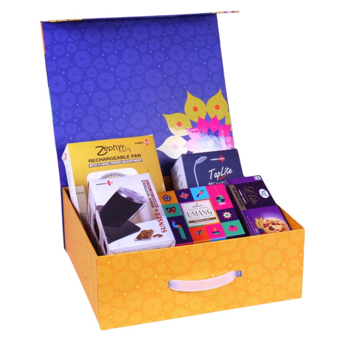 Open magnetic gift box showing rechargeable fan, lamp, mug, cookies, and pooja dhoop cones
