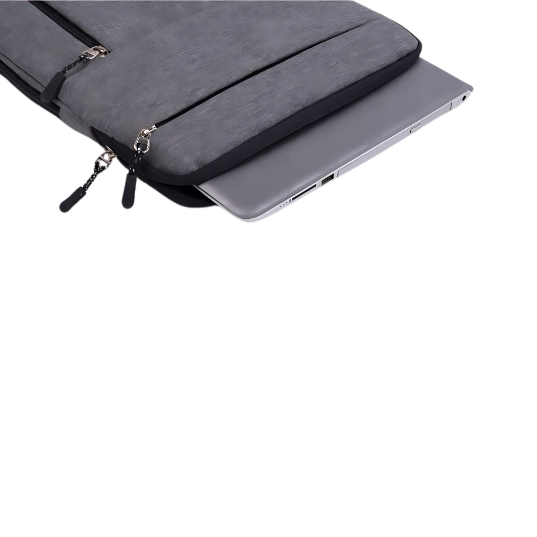 Grey laptop sleeve with zipper compartments holding laptop