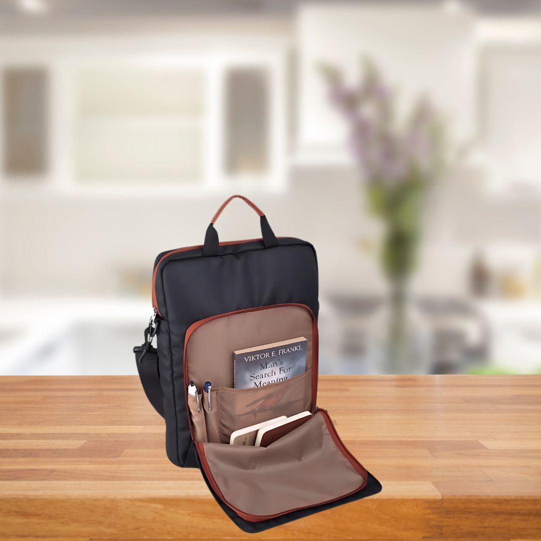 Minimalistic sling laptop bag open with laptop and essentials inside