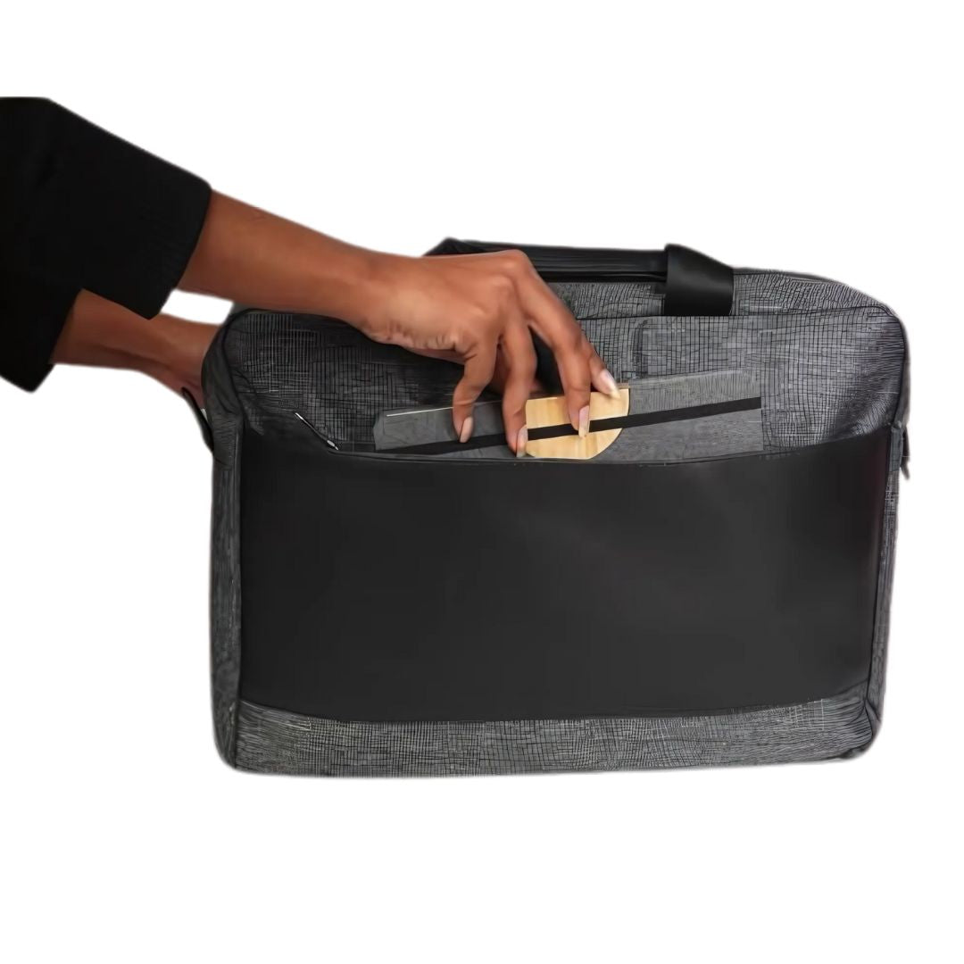 Graphite laptop bag with hand placing essentials in outer pocket