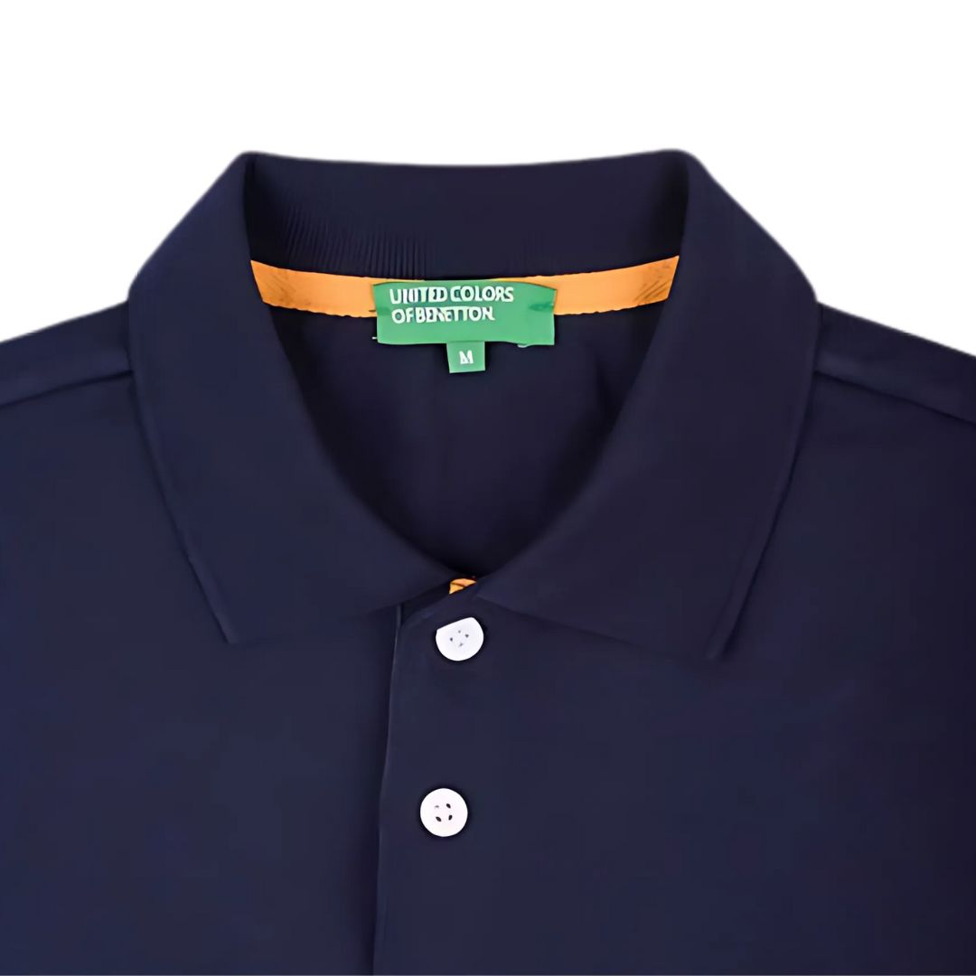 Close-up of UCB navy blue polo t-shirt collar and buttons
