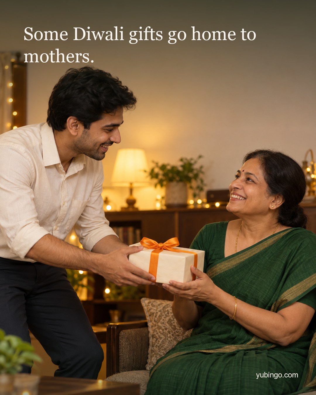 In a warm home lit with fairy lights, a young man in office clothes hands a gift box with a marigold ribbon to his smiling mother. Text: Some Diwali gifts go home to mothers.